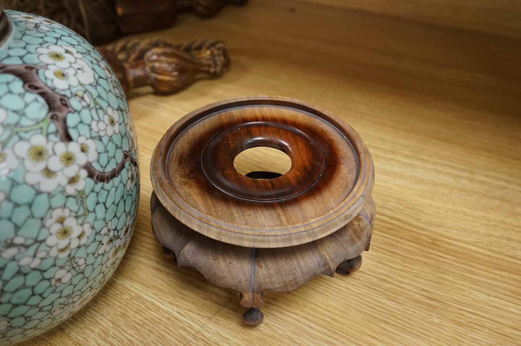 A Chinese famille verte enamelled prunus jar, 19th century, with wood cover and stand, 25cm high